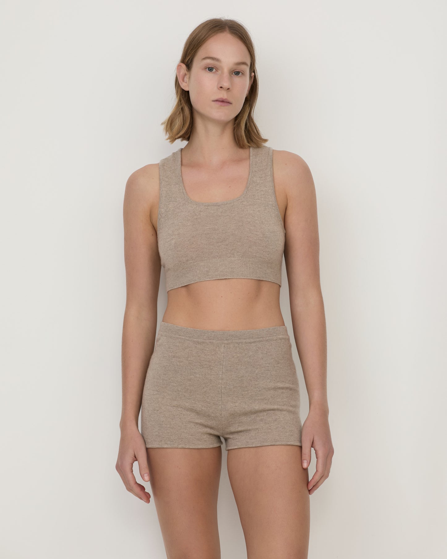Woman wearing Casasola Lucia knitted cashmere culottes in stone with matching cropped top