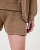 Model wears Casasola  Alba knitted cotton camel shorts - detail view