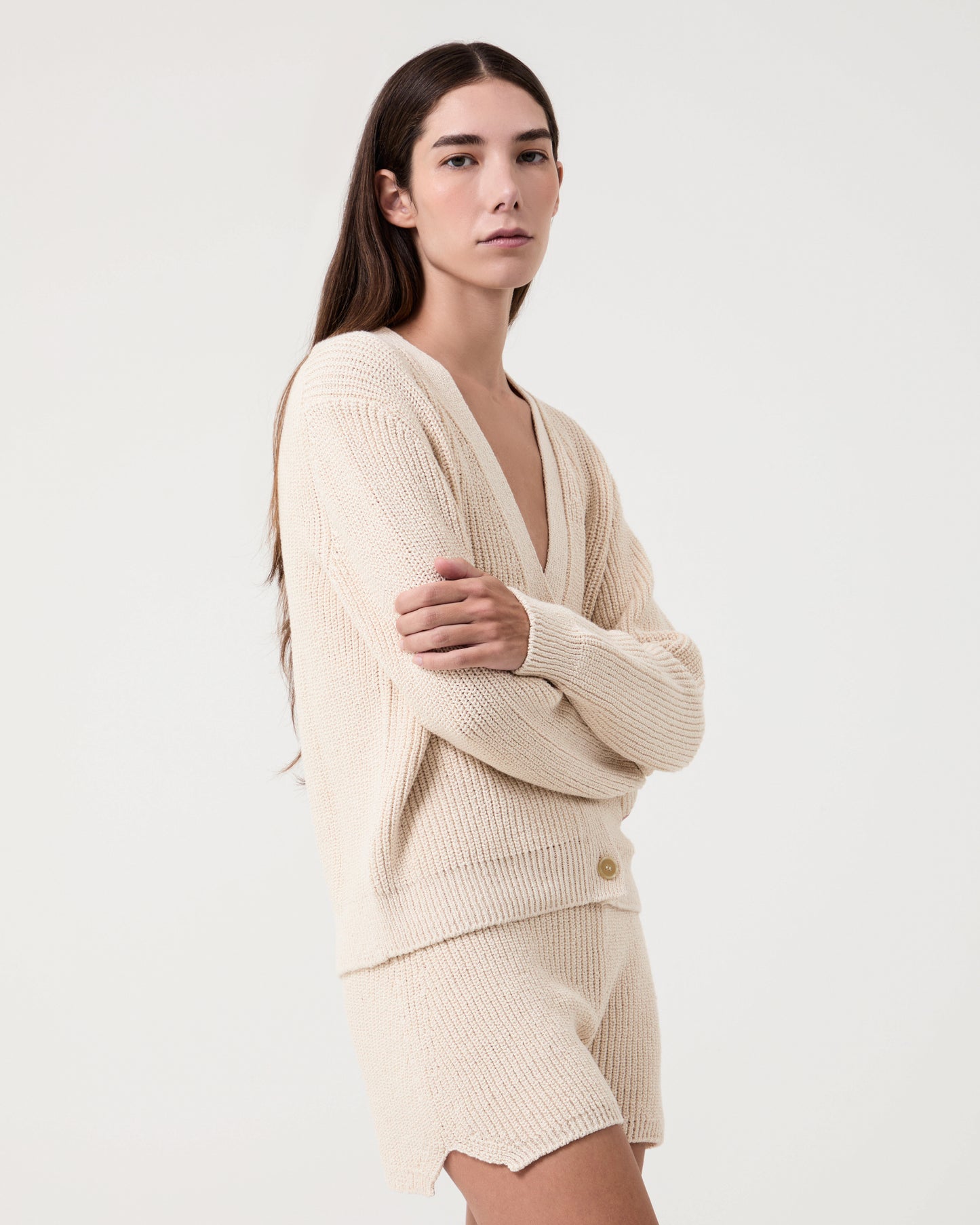 Model wears  Alba knitted cotton white shorts with matching cardigan 