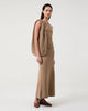 Woman wears Casasola Carolina knitted cotton camel tank top with matching skirt and bag