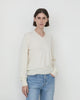 Model wearing Casasola Giada knitted wool classic v-neck sweater in Ivory - front view