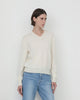 Model wearing Casasola Giada knitted wool classic v-neck sweater in Ivory - profile view