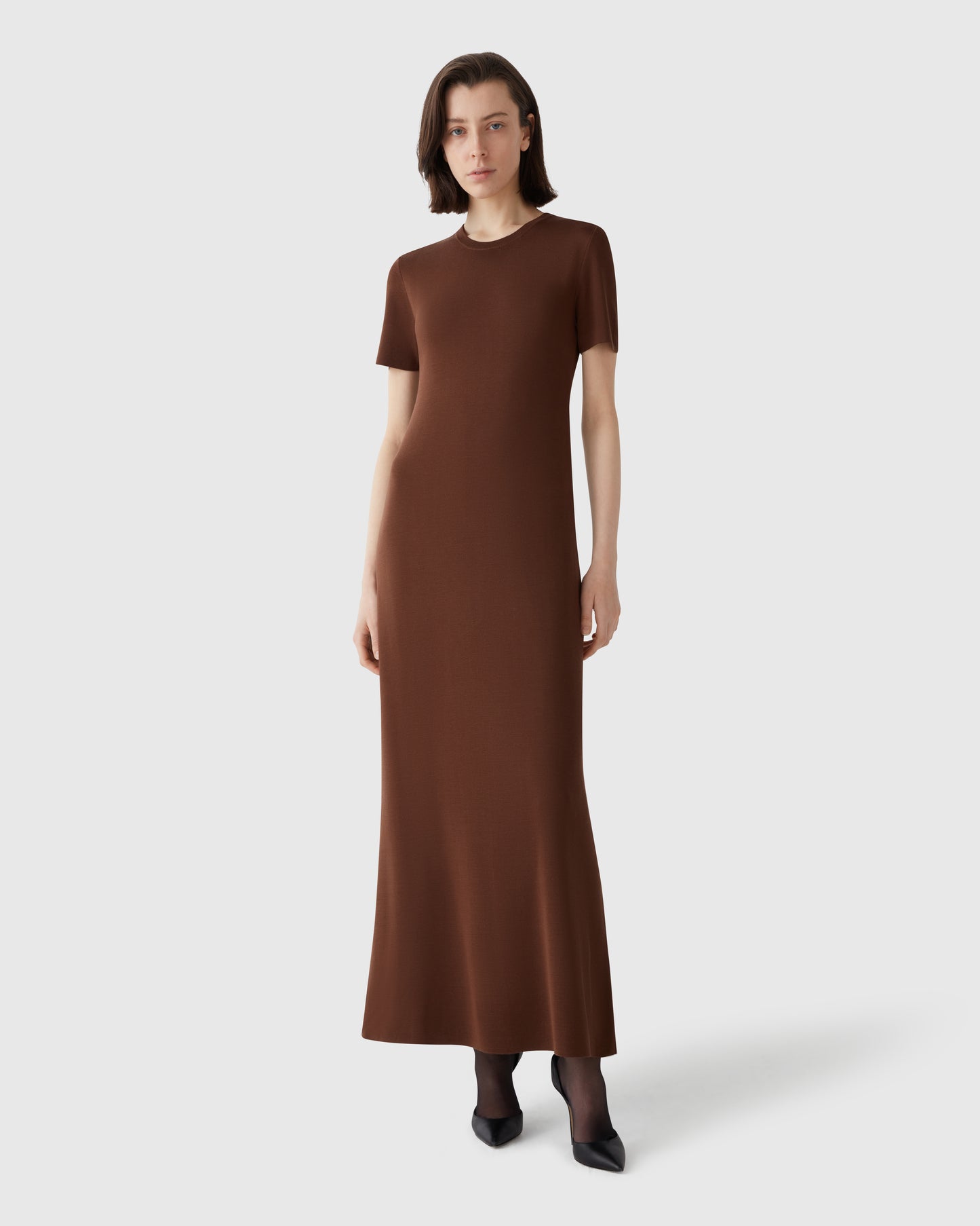 Model wearing Casasola compact-knit mid-length t-shirt dress in brown - front view