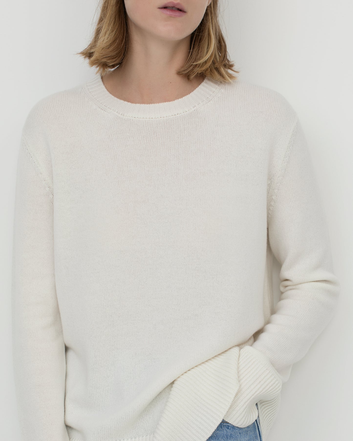 Model wears Casasola Maria knitted cashmere oversized crewneck sweater - detail view