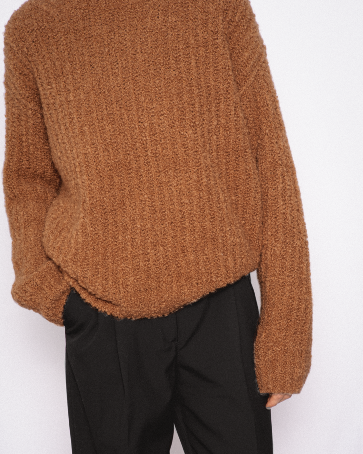 Model wears Casasola Orso Cashmere Silk Boucle Brown Crewneck Sweater with high-waisted trousers - front view
