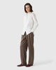 Model wearing Casasola brown flannel trousers styled with a cream shirt