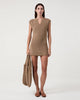Model wears Casasola Costanza knitted cotton shoulder camel bag with matching mini-dress