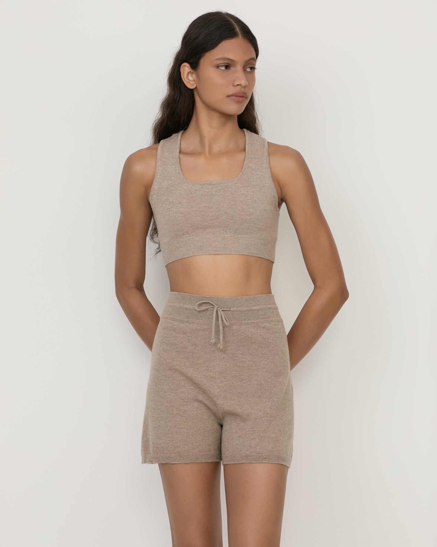 Woman wearing Casasola Fina knitted shorts in cashmere with drawstring with matching cropped top