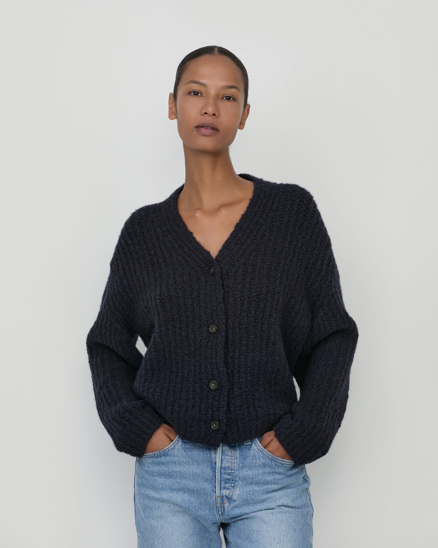 Woman wearing Casasola Fumo Knitted Cashmere Silk Boucle Cardigan in Navy - Front View