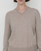Woman wears Casasola Giada wool V-Neck Sweater in Stone - detail view