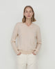 Woman wears Casasola Giada wool V-Neck sweater in Sand - front view