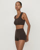 Woman wearing Casasola Lucia knitted cashmere culottes in brown with matching cropped top