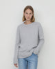 Woman wears Casasola Maria knitted cashmere oversized crewneck sweater in grey - front view