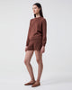 Woman wears Nina knitted cotton crewneck Brown with matching Aba shorts