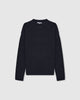A navy-colored, oversized, four-ply knitted cashmere-silk sweater with a ribbed mock neckline, displayed on a white background.