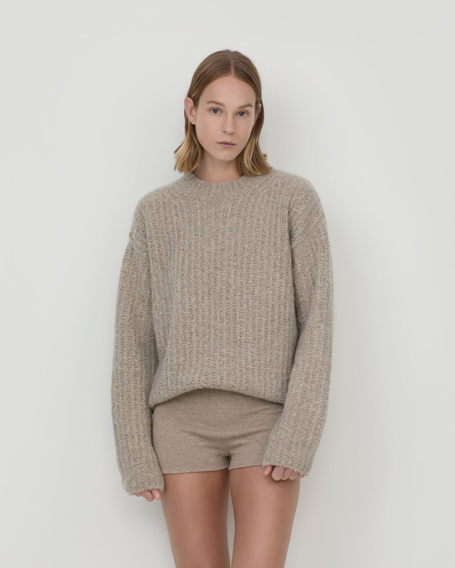Casasola Orso beige-colored, oversized, four-ply knitted cashmere-silk sweater with a ribbed mock neckline, front view.