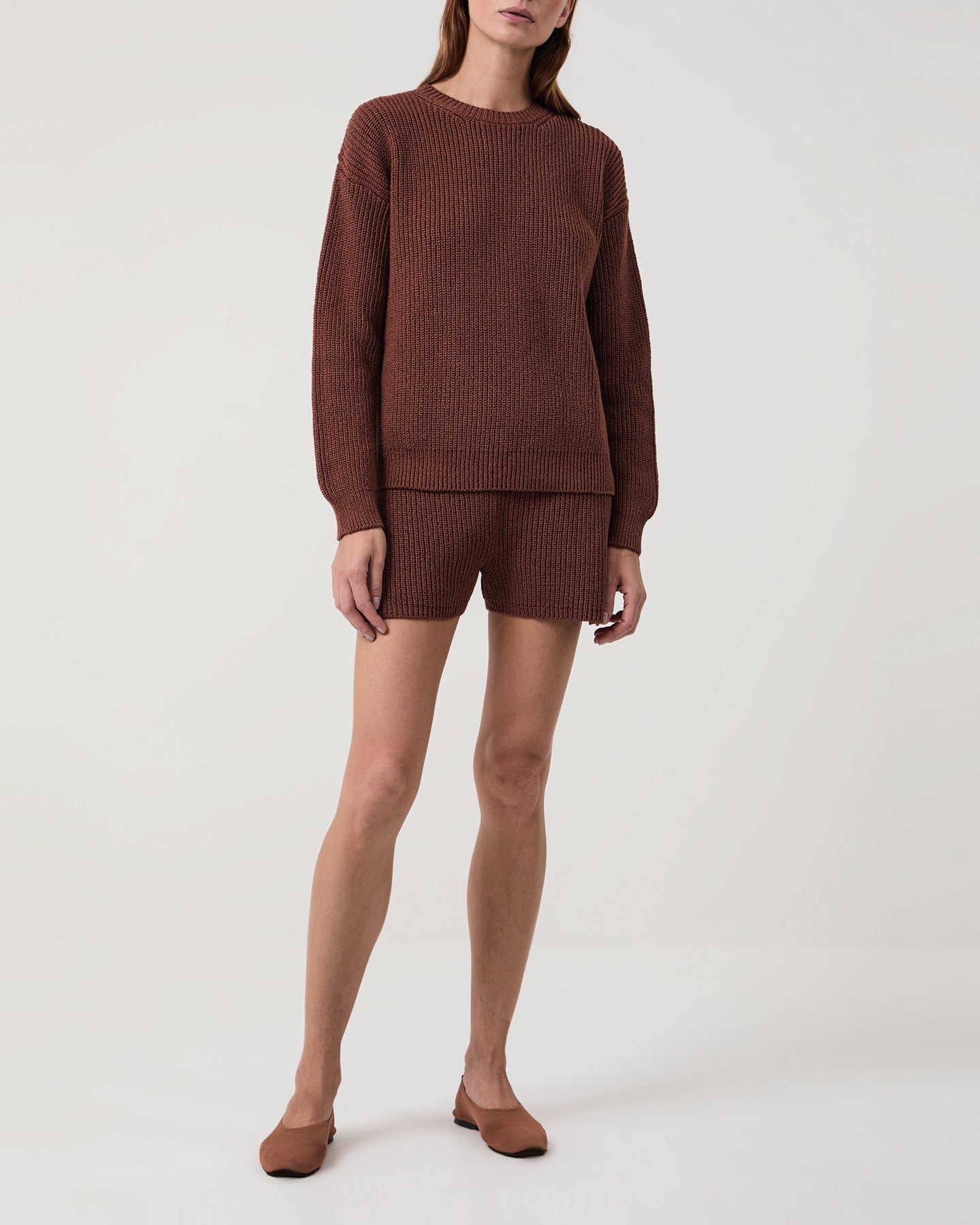 Woman wearing Ottavia heavyweight knitted cotton brown crewneck with matching shorts