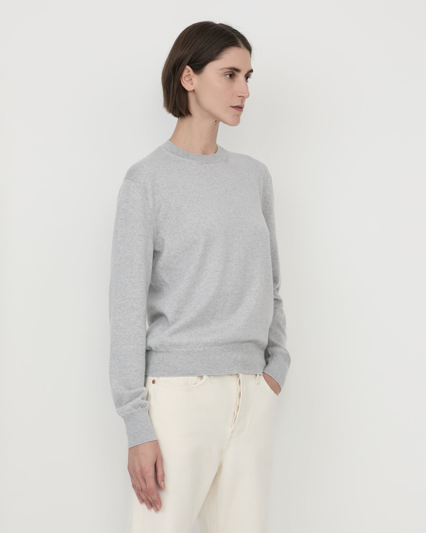 Woman wearing Casasola Pia knitted merino wool grey crewneck - side view