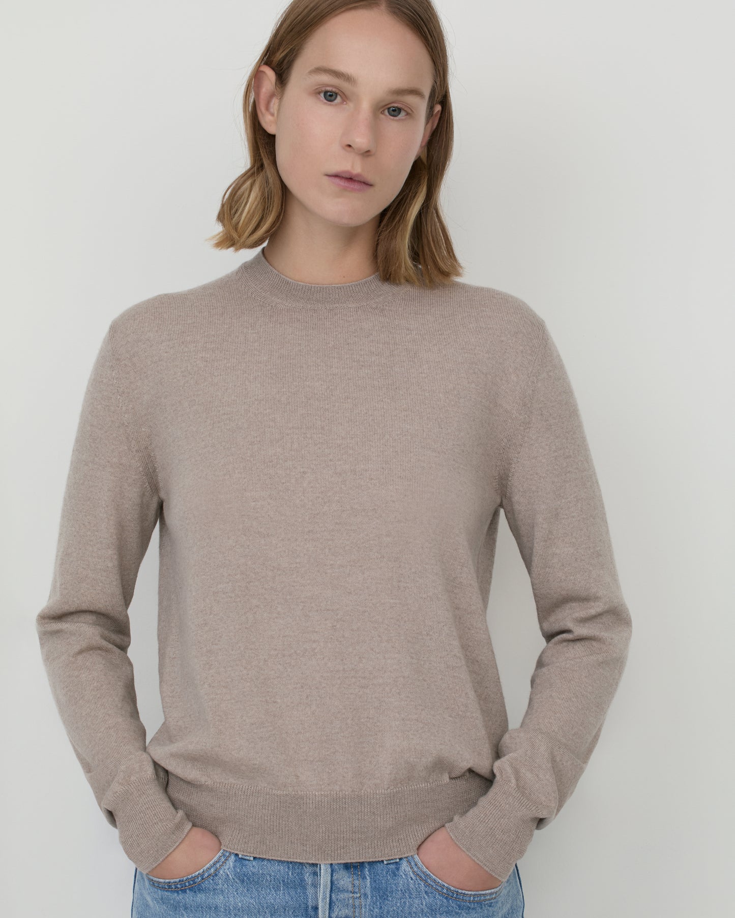 Model wears Pia knitted merino wool stone crewneck 