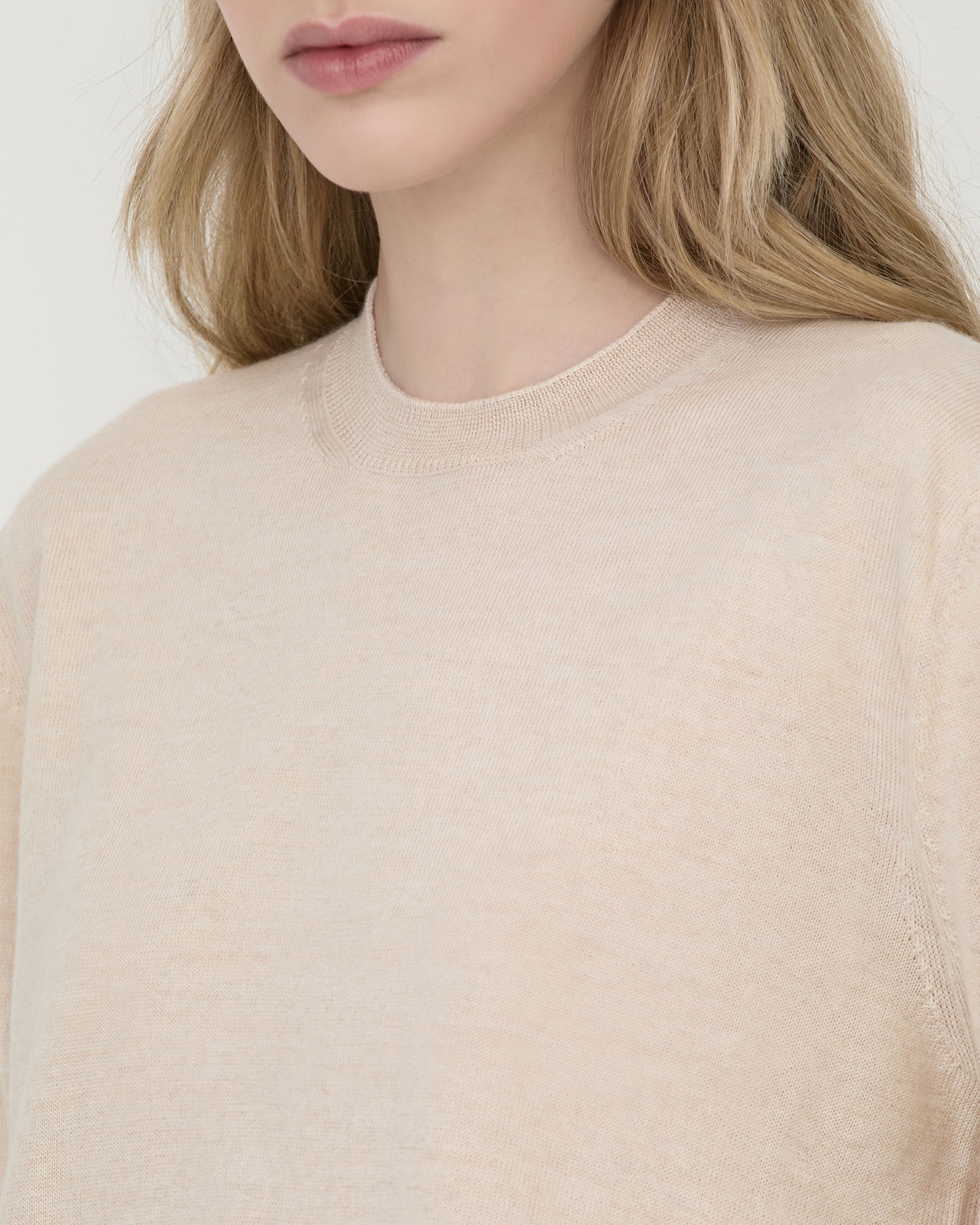 Model wearing Casasola Pia classic knitted merino wool white crewneck - detail view