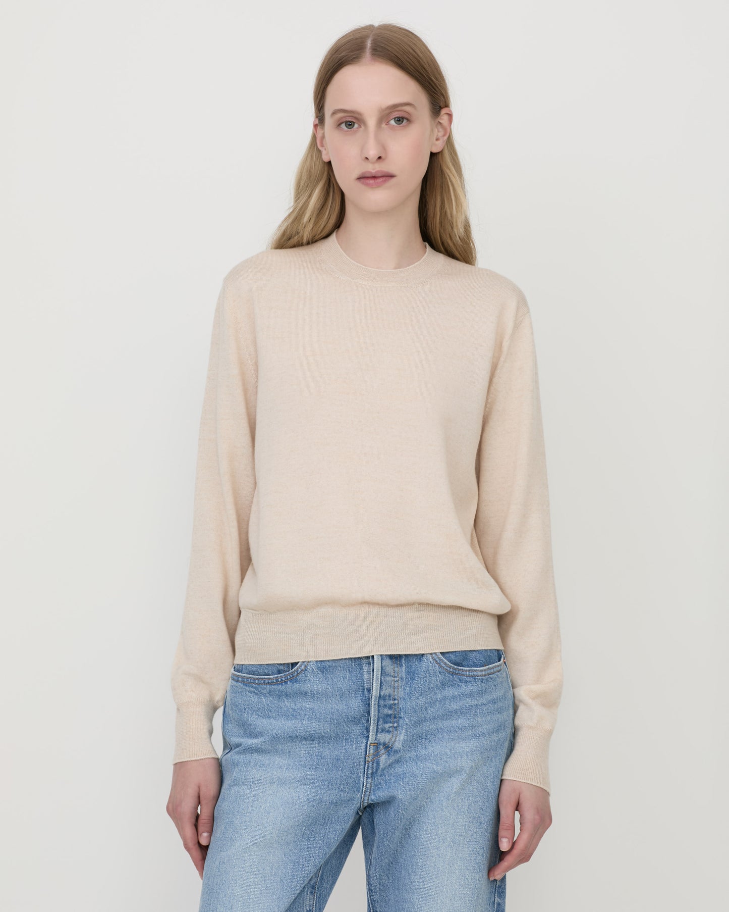 Woman wearing Casasola Pia knitted merino wool white crewneck with jeans