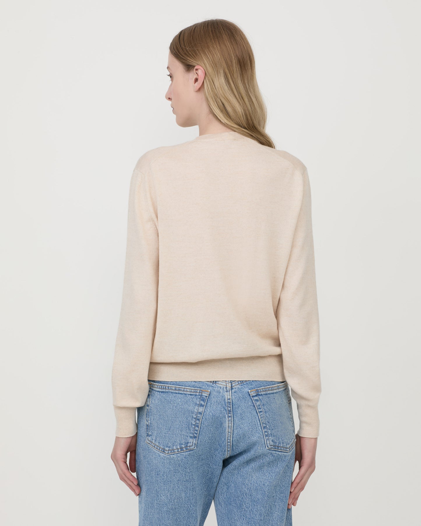 Woman wearing Casasola Pia knitted merino wool white crewneck - back view